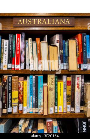 Books on Australia in the Melbourne Athenaeum Library. Old style library bookcase with sign Australiana famous books about Australian history, society Stock Photo