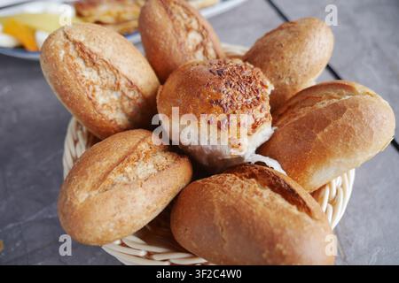 Fresh bread rolls in a basket at a local bakery Stock Photo