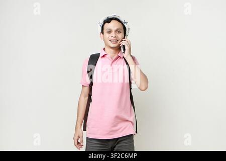 Asian man backpacker making a phone call. digital nomad and travelling concept. on isolated background Stock Photo
