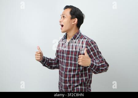 Happy asian indonesian man with thumb up gesture on isolated background Stock Photo