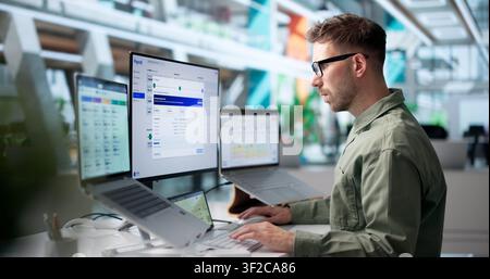 Payroll Manager Reviews Employee Salary Details Using Laptop Software Tool. Stock Photo