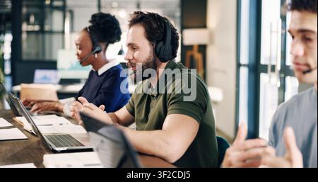 Headset, laptop and technical support consultant in office for crm, help desk or online consultation. Man, coworking and call center agent in Stock Photo