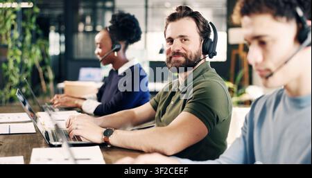 Headset, man and portrait of call center agent with laptop in office for crm, help desk or consultation. Mic, coworking and technical support Stock Photo