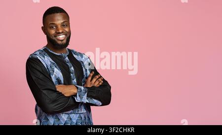 Confident black man in traditional african clothes with arms crossed Stock Photo