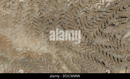 Aerial top view tire track on dirt sand mud, Texture of wet mud road with puddle and Tyre or tire track in countryside, Wheel tyre or tire track on mu Stock Photo
