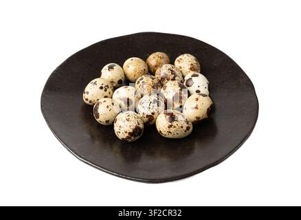 Quail Eggs Isolated, Diet Egg on Black Plate, Healthy Breakfast, Natural Organic Nutrition, Salad Ingredient Spotted Quail Egg on White Background Stock Photo
