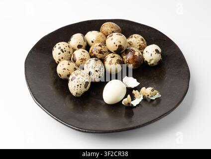 Quail Eggs Isolated, Diet Egg on Black Plate, Healthy Breakfast, Natural Organic Nutrition, Salad Ingredient Spotted Quail Egg on White Background Stock Photo