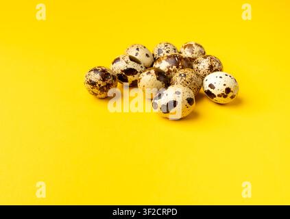 Quail Eggs, Diet Egg Group, Healthy Breakfast, Natural Organic Nutrition, Salad Ingredient Spotted Quail Egg on Yellow Background Stock Photo