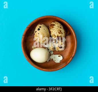 Quail Eggs, Diet Egg in Wood Bowl, Healthy Breakfast, Natural Organic Nutrition, Salad Ingredient Spotted Quail Egg on Blue Background Stock Photo