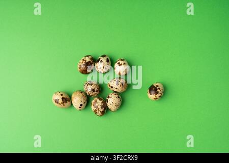 Quail Eggs, Diet Egg Group, Healthy Breakfast, Natural Organic Nutrition, Salad Ingredient Spotted Quail Egg on Green Background Stock Photo