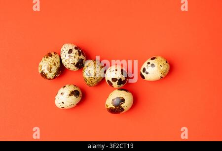 Quail Eggs, Diet Egg Group, Healthy Breakfast, Natural Organic Nutrition, Salad Ingredient Spotted Quail Egg on Red Background Stock Photo