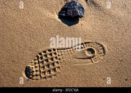 Shoe prints in the sand Stock Photo