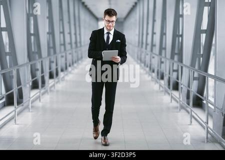 Smiling urban business man holding digital tablet Stock Photo
