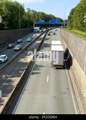 Aerial view of traffic entering the Velsertunnel on a highway with cars and trucks driving between concrete walls in Velsen-Zuid, Noord-Holland, Nethe Stock Photo