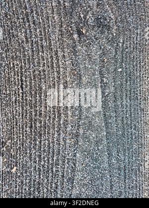 This image features a detailed, closeup view of a rough, textured surface composed of gray and white fibers with a distinct vertical pattern Stock Photo