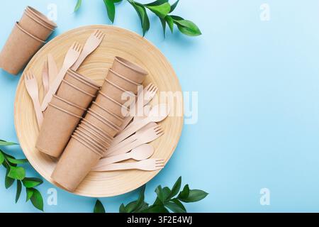 Eco friendly concept. Bamboo dish and cutlery, paper cups isolated on Stock Photo