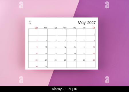 May 2027 blank calendar page on purple two tone color background. Stock Photo