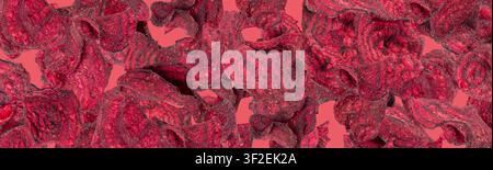 Dry beetroot chips pattern, dried sliced red beet flakes textured background, beet root pieces and chips, dehydrated deep fried vegetable root heap on Stock Photo