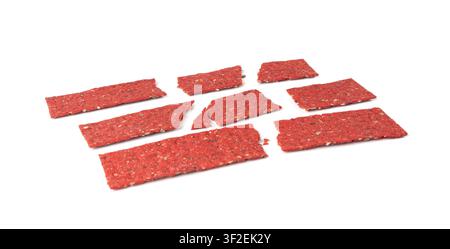 Beetroot crackers pieces isolated, crumbled thin rusk beet root bread pile, broken red diet multigrain crispbread with various seeds, crisp bread, lon Stock Photo