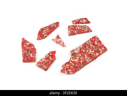 Beetroot crackers pieces isolated, crumbled thin rusk beet root bread pile, broken red diet multigrain crispbread with various seeds, crisp bread, lon Stock Photo