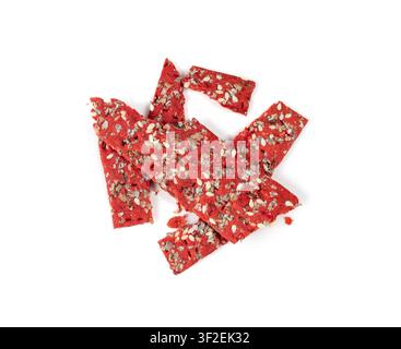 Beetroot crackers pieces isolated, crumbled thin rusk beet root bread pile, broken red diet multigrain crispbread with various seeds, crisp bread, lon Stock Photo