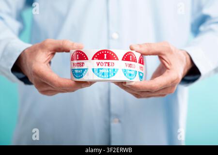 Man holding I voted today stickers roll Stock Photo