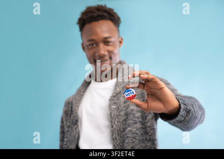 African american Man with Vote button in hand Stock Photo