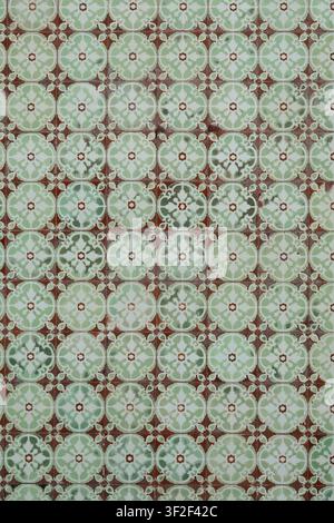 Detailed close-up of small green and brown diamond-patterned ceramic tiles, showcasing traditional Portuguese decorative tilework Stock Photo