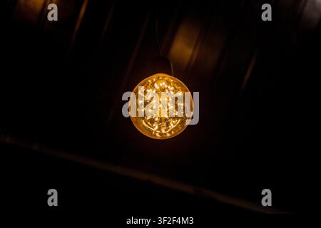Glowing Edison Light Bulb in the Dark Stock Photo