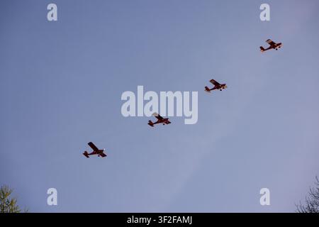Druskininkai, Lithuania - 23 May 2026: View of four small propeller planes flying in formation against a clear blue sky. Stock Photo