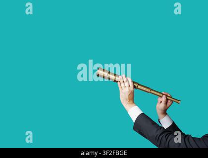 Hands in business attire hold a pirate telescope, isolated against a flat-design background. Business analytics and strategic thinking. Stock Photo