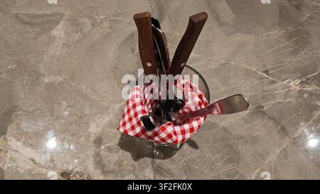 Complete dining utensil set arranged on a dining table. Stock Photo