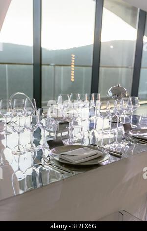 Elegant fine dining table setting with crystal glassware prepared for luxury event or wedding reception Stock Photo