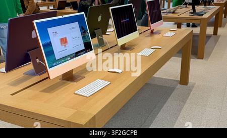 05.05.2026 - Berlin, Germany. Apple computer on a wooden table in a modern retail environment Stock Photo