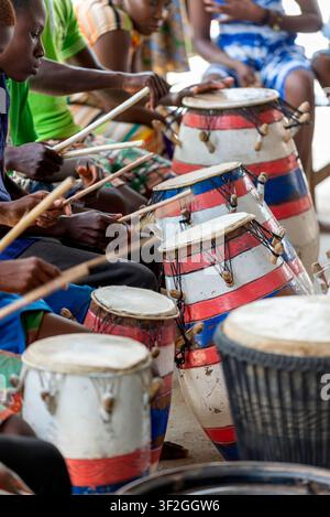 Hands strike traditional drums in close-up, Somanya, Ghana Stock Photo
