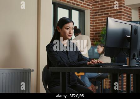 System Engineer Smiling After Successful Code Compile at a software development desk after compiling source code successfully, showing algorithm work and coding success. Stock Photo