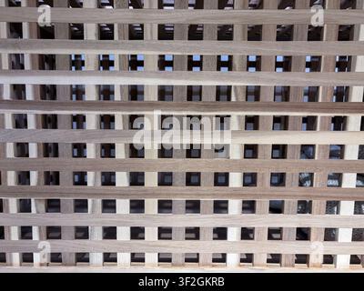 Natural wooden lattice slats forming an airy geometric furniture texture background Stock Photo