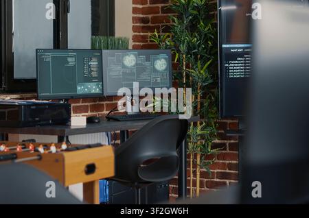 Desk with multiple computer monitors displaying neural network visualisation and artificial intelligence parsing code with multiple monitors, programming code and cloud computing visuals inside an. Stock Photo