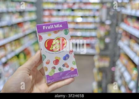 Jelly Belly Fruit Mix pack of fruit mix jelly beans in hand in supermarket, buy product in store, supermarket, grocery store, Rewe, Germany Stock Photo