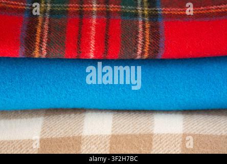 Folded warm scarves: checkered beige, checkered red and blue Stock Photo