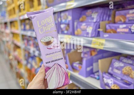 Close-up of onion-flavored long chips in purple packaging on supermarket shelf, Kaufland, product, supermarket, Germany Stock Photo