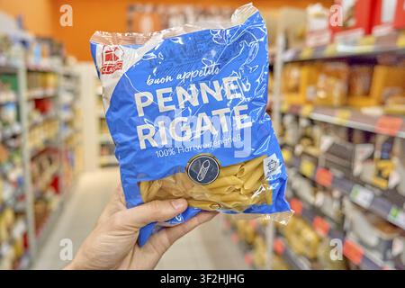K-Classic, hand holding Penne Rigate pack in supermarket, pack of noodles, supermarket, Kaufland, Germany Stock Photo