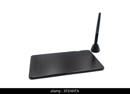 Black digital graphics tablet with a stylus on a white background Stock Photo