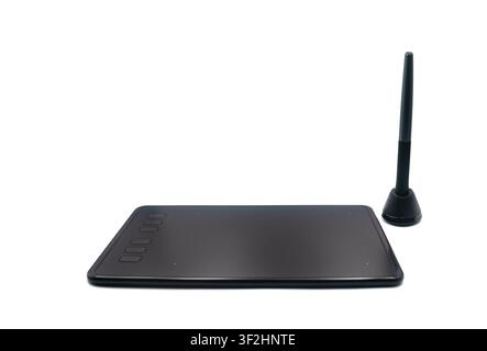 Black digital graphics tablet with a stylus on a white background Stock Photo
