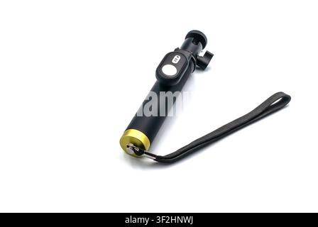 Portable selfie stick with bluetooth remote isolated on white background Stock Photo