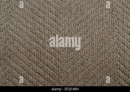 Detailed macro shot of soft brown woven fabric with textured diamond weave pattern, ideal for interior, furniture and design backgrounds. Stock Photo
