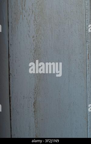 Macro detail of old distressed wood with peeling light blue paint and exposed wood grain for vintage background Stock Photo