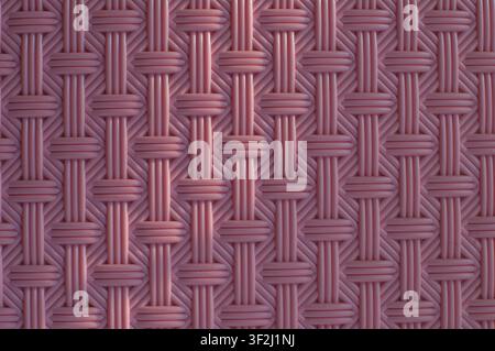 Detailed macro of pink woven plastic rattan pattern with geometric interlaced design for modern background Stock Photo
