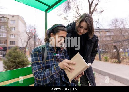 Students reviewing notes together on campus Stock Photo