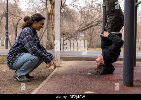 Young woman doing a headstand at the park Stock Photo